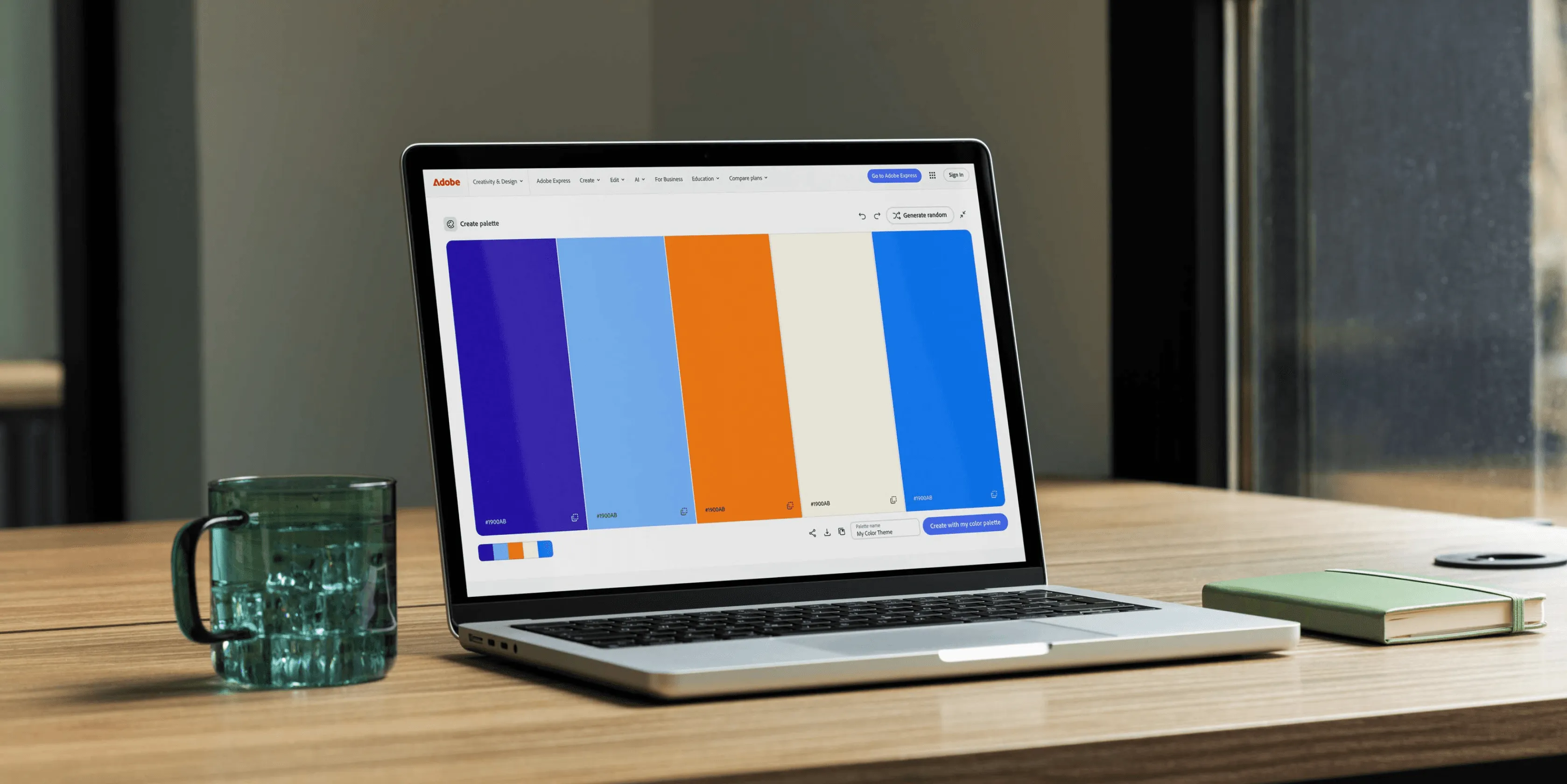 Adobe Color palette creation interface showing a color palette with purple, blue, orange, cream, and royal blue swatches on a laptop